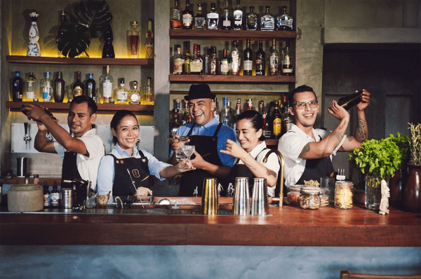 team of bartenders pose for photo behind zapote bar